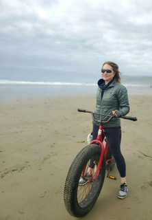 Dr. Brandith Irwin on a bike at a beach